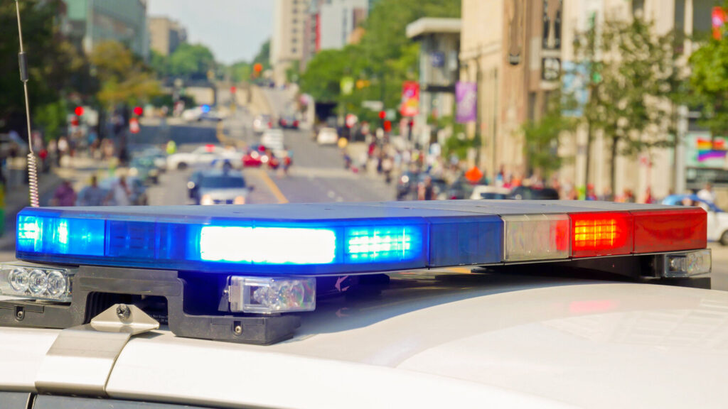 A police car rushes to the emergency call with lights turned on